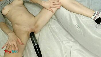 Horny amateur babe rips up her swimsuit and plays with a big dildo
