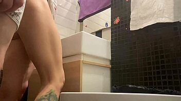 Tiny dick gets a handjob in public bathroom