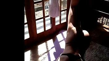 Young woman trains in panties for neighbor to see
