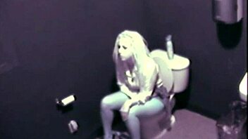 a blonde babe caught fingering herself in public restroom on cam