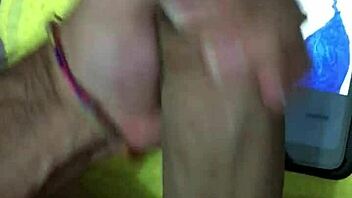 In a homemade setting, a petite latina brunette with big tits and a cute smile receives a cumtribute from a monster cock, leading to a cumshot for her new hot fan.