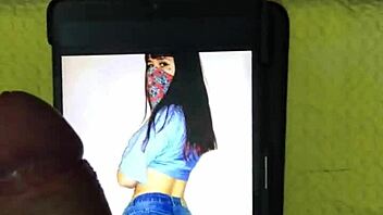 In a homemade setting, a petite latina brunette with big tits and a cute smile receives a cumtribute from a monster cock, leading to a cumshot for her new hot fan.