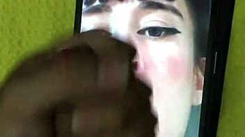 In a homemade setting, a petite latina brunette with big tits and a cute smile receives a cumtribute from a monster cock, leading to a cumshot for her new hot fan.