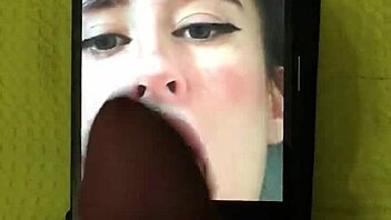 In a homemade setting, a petite latina brunette with big tits and a cute smile receives a cumtribute from a monster cock, leading to a cumshot for her new hot fan.