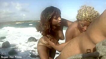 Nina Rivera and Porsha Carrera blow dick on rocks.