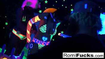 Romi Rain and Dani's lesbian fun under black lights, with big tits and ass play