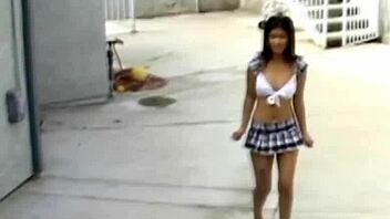 An Asian babe kneels naked, eagerly sucking a hard cock in a passionate blowjob scene.