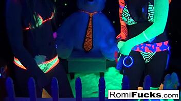 Romi Rain and Dani's lesbian fun under black lights, with big tits and ass play
