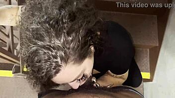 Msthroatmagic expertly sucks a big black cock in a public stairwell, showing off her deepthroat skills outdoors.