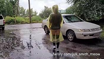 Young woman in yellow raincoat exposes herself in public