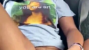 ebony woman fingers wet pussy in public car, teasing passersby with risky outdoor masturbation