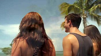 Two girls in bikinis show off their bodies on the beach