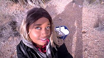 Cute girlfriend gives a sloppy blowjob to her boyfriend in the desert