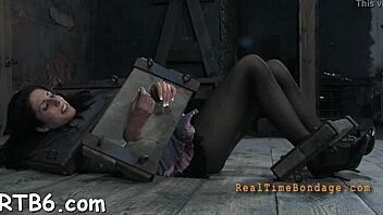 Gagged beauty with clamped nipples enjoys BDSM play