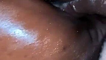 Oiled ebony beauty takes a hard cock. Her ass shakes with every deep thrust.