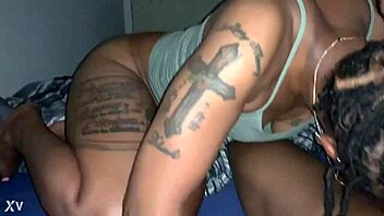 Black babe with big tits and tattoos sucks a big black dick