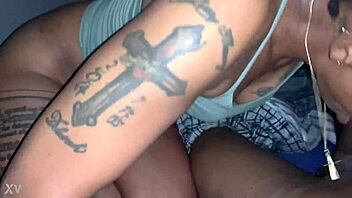 Black babe with big tits and tattoos sucks a big black dick