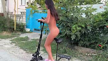 Nude girl rides scooter through busy city