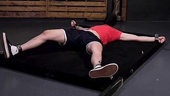 Gay bondage video features dominant top and submissive bottom