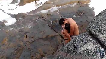 Lady MILF gets her big tits and ass oiled up on the beach