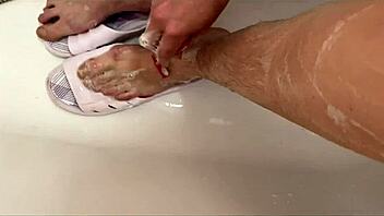 Cute amateur with hairy legs enjoys shower and shaving in close-up video