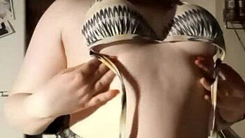 want to see this busty girl playing with her tits for free?