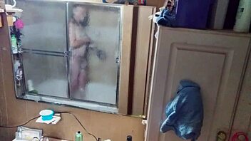 Long-haired beauty in panties and briefs in mirrored bathroom