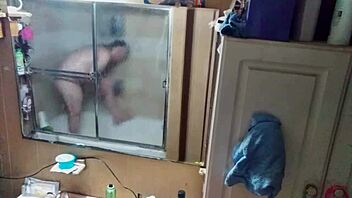 Long-haired beauty in panties and briefs in mirrored bathroom