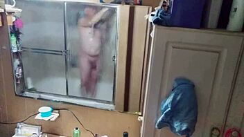 Long-haired beauty in panties and briefs in mirrored bathroom