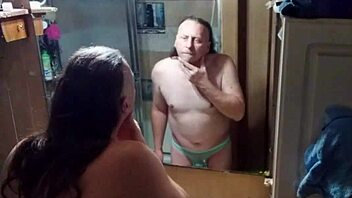 Long-haired beauty in panties and briefs in mirrored bathroom