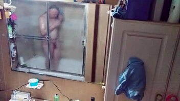 Long-haired beauty in panties and briefs in mirrored bathroom