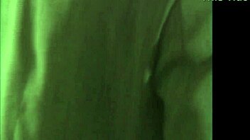 doctor examines patient in hospital setting with brunette assistant