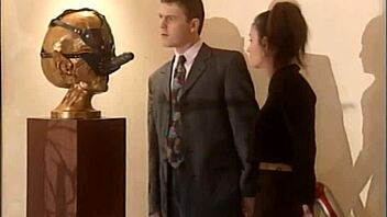 doctor examines patient in hospital setting with brunette assistant