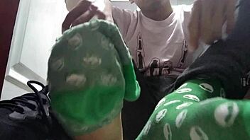 Twink shows off long green socks and sweaty feet up close