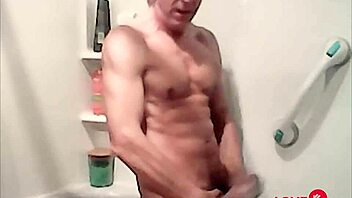 In the bath, the gay daddy jerks off during his workout session