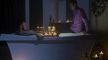 Neighbors indulge in some steamy gay action in a candlelit bathtub