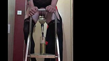 Bisexual sissy enjoys the taste of his own urine while standing on a ladder