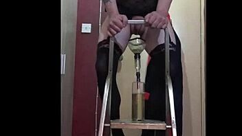 Bisexual sissy enjoys the taste of his own urine while standing on a ladder