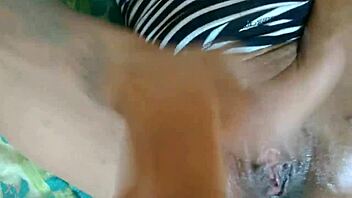 Ebony girl plays with herself using fingers.