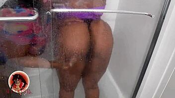 Two bad girls intensely sharing a dildo in the shower, squirting and licking pussy.
