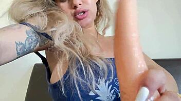 Hot blonde sucks on a big dildo and deepthroats it like a pro