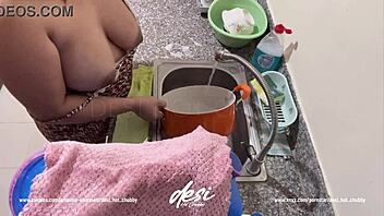 Indian bhabhi gives a peek of her big tits while doing household chores
