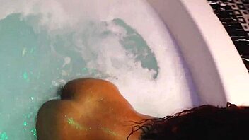 Horny couple enjoys a steamy threesome in a jacuzzi