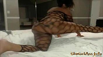 ebony woman poses in fishnets for a photoshoot