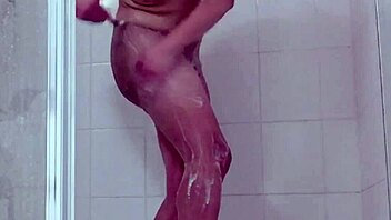 Ladyboy gets naked and shaves her hairless body in the shower