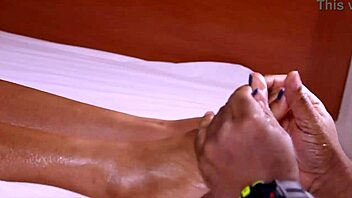 Puffy tits and pretty feet give footjob in barefoot video