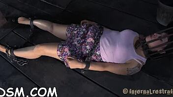 Stunning vixen confined in a cage, revealing her smooth nether region