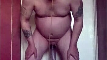 Mark Wright, a bisexual man, indulges in self-pleasure by inserting a dildo into his own anus and simultaneously swallowing his own urine.