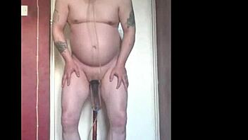 Mark Wright, a bisexual man, indulges in self-pleasure by inserting a dildo into his own anus and simultaneously swallowing his own urine.