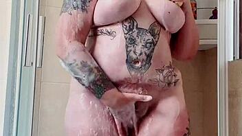 Puffy Tattooed Curvy Babe Plays with Hairy Beaver in Shower. Barefoot Feet Wet and Wild!